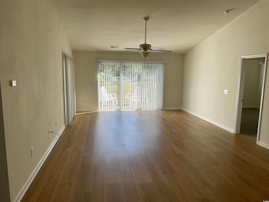 Spare room featuring wood finished floors and a ceiling fan