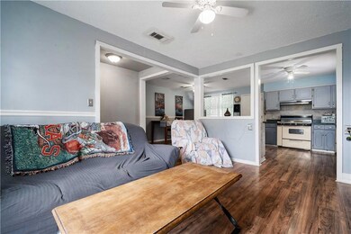 Living area featuring ceiling fan, a textured ceil