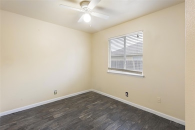 Unfurnished room with dark wood-style floors and 