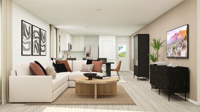 Living area with light wood-style floors and baseboards