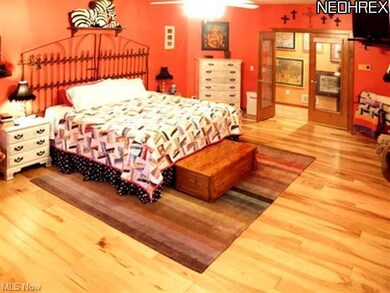 Master bedroom with hickory wood floor and gas fir
