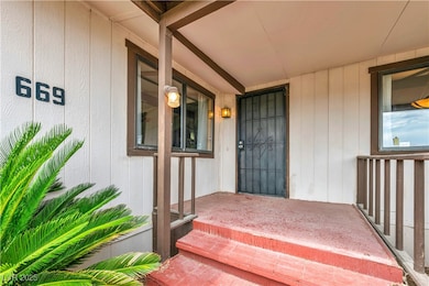 Doorway to property featuring covered porch