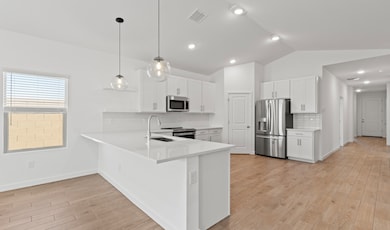 Kitchen features vaulted ceiling