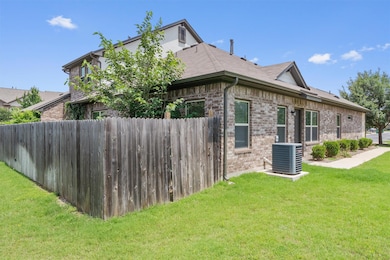 View of home's exterior with cooling unit, brick 