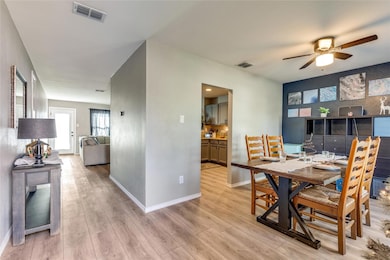 Dining space featuring ceiling fan and light hardw
