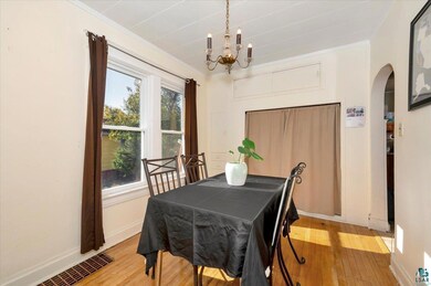 Dining room with crown molding, a notable chandeli