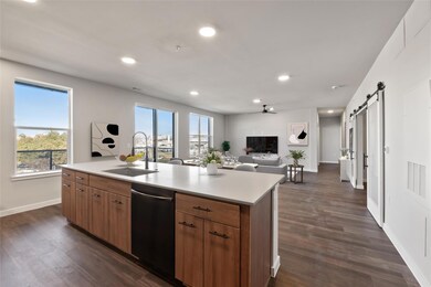 Kitchen featuring dishwasher, a barn door, light 