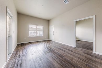 Unfurnished bedroom featuring visible vents, base