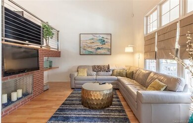Living room with windows overlooking front porch