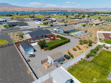Aerial view of backyard. Multiple out buildings for extra storage.