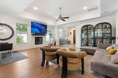 Living area with a fireplace, visible vents, a tr