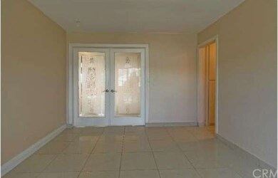 Living room area view of the double door entry int
