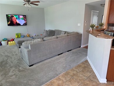 Living room featuring ceiling fan, light carpet, b