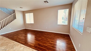 Spare room with wood finished floors, stairs, and