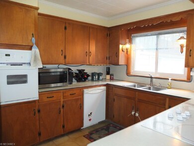 Kitchen has a countertop range and wall oven.