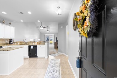 Kitchen featuring kitchen peninsula, white cabinet