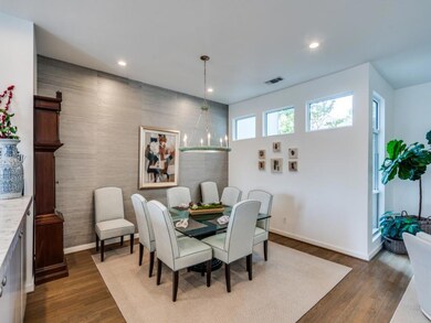 Dining area with sleek grasscloth wall covering