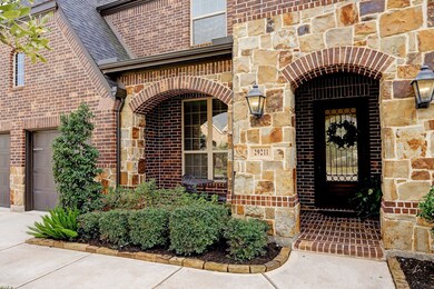 Sit out and enjoy watching the kids play on the cul de sac, or drink a cup of morning coffee , on this brick and stone covered front porch with paved brick floor, arched stone and brick details with an oversized glass and wrought iron front door.