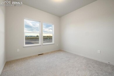 Carpeted empty room featuring baseboards