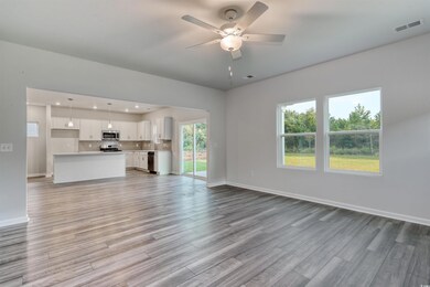 Unfurnished living room with ceiling fan, light ha