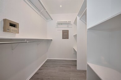  Primary closet is a  haven with shelving and stra