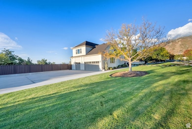 View of front of home with concrete driveway, a garage, and a mountain view