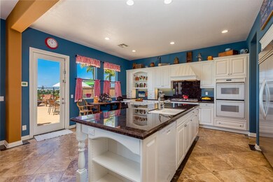 Kitchen with built-in island, eat-in area and acce