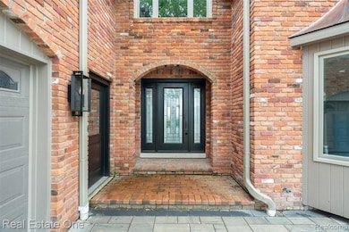 Entrance to property featuring brick siding