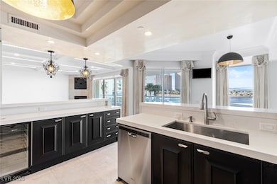 Kitchen featuring beverage cooler, dark cabinetry,