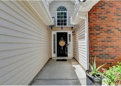 Doorway to property with brick siding