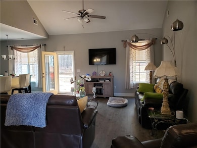 Living room with ceiling fan, wood-type flooring, 
