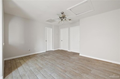 Spare room featuring a ceiling fan and light wood finished floors