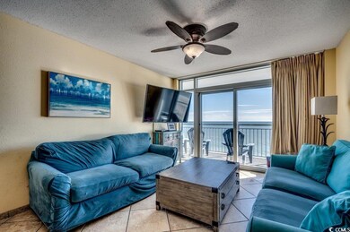 Tiled living room with floor to ceiling windows, c