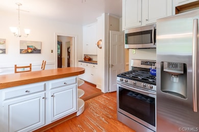The kitchen is outfitted with stainless steel appliances and a gas stove.