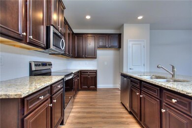 Kitchen featuring backsplash, stainless steel appl
