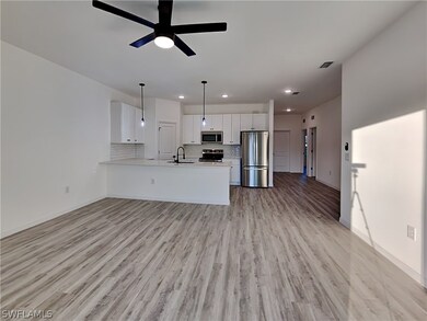 This is a picture of a previously completed home.. Unfurnished living room with light hardwood / wood-style flooring, sink, and ceiling fan