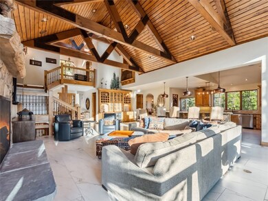 Living area featuring wood ceiling with exposed be