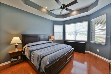 Master bedroom with wood floors and trey ceiling