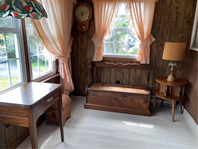 enclosed side porch with carpeting and newer windo