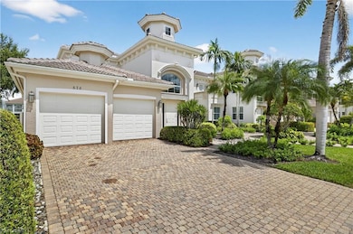 Mediterranean / spanish house with decorative driveway, stucco siding, an attached garage, and a tiled roof