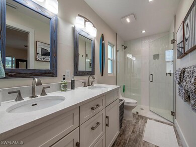 Bathroom with an enclosed shower, hardwood / wood-