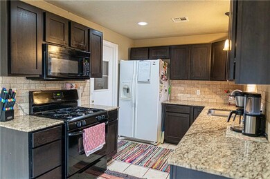 Kitchen with Granite countertop, and Stone backspl