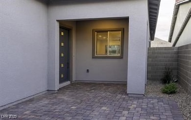 View of exterior entry featuring stucco siding