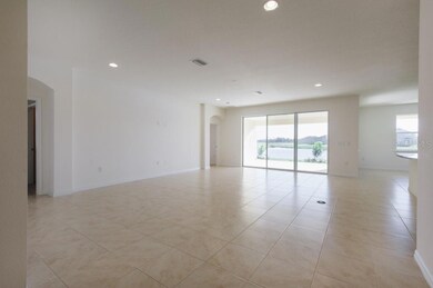 Great room with sliding glass door to large covered, screened lanai
