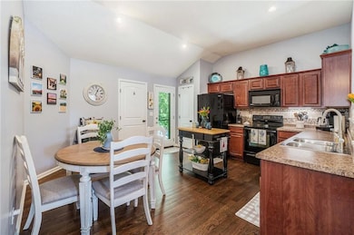 The eat-in kitchen features wood floors, lots of cabinet space, a pantry, and direct access to the patio.