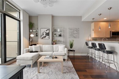Living area with dark wood finished floors and recessed lighting