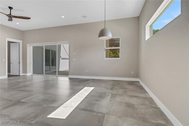 Unfurnished room featuring a ceiling fan, concrete