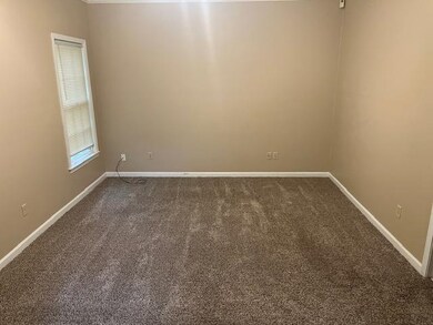 Unfurnished room with dark colored carpet
