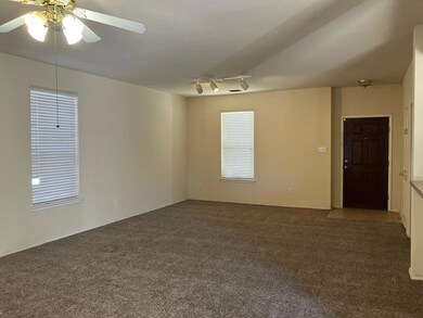 Carpeted spare room featuring ceiling fan, a healt