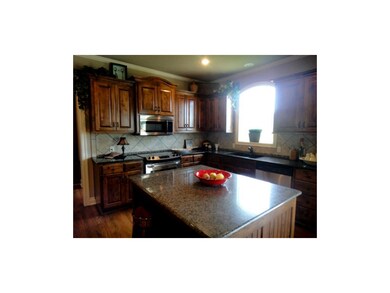 Beautiful alder cabinets, arched window, granite c